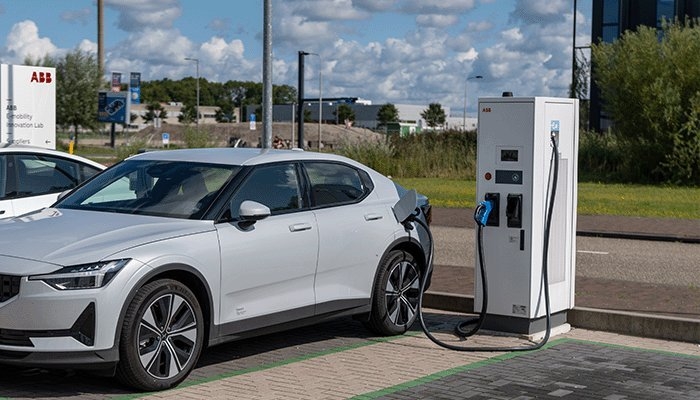 Een witte auto wordt opgeladen aan een laadpaal